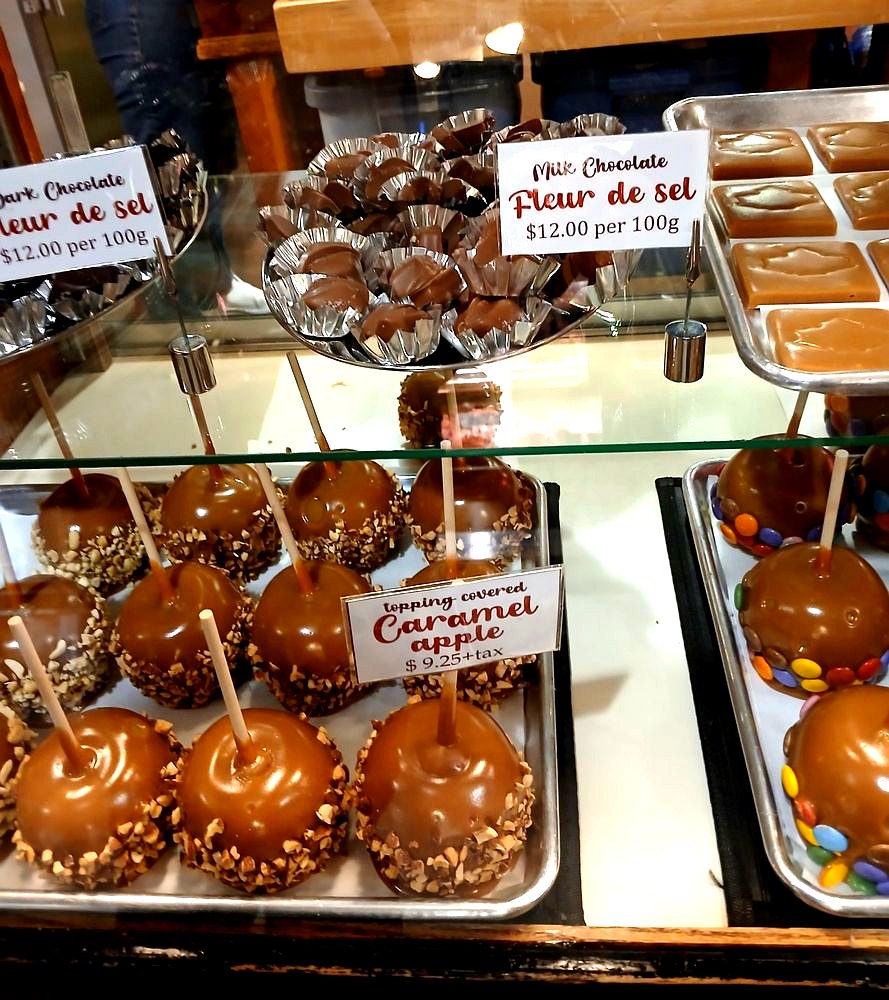 Caramel apples and fleur de sel caramels in the case at Olde World Fudge